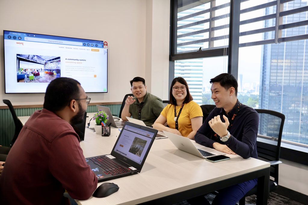 four people discussing in a meeting room